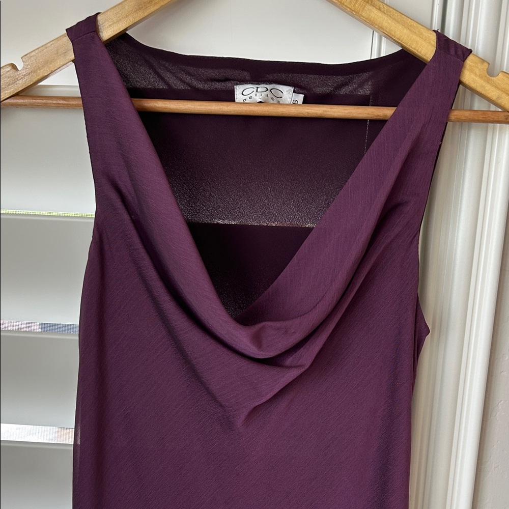 Beautiful silkly dress with black laced trim. Sleeveless and drap neckline.